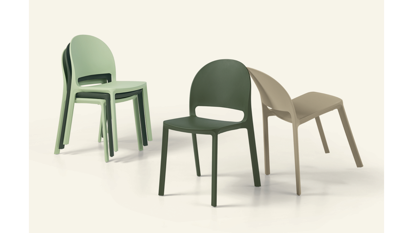 Three molded plastic dining chairs in sage green, dark forest green, and beige, arranged on a light cream background.